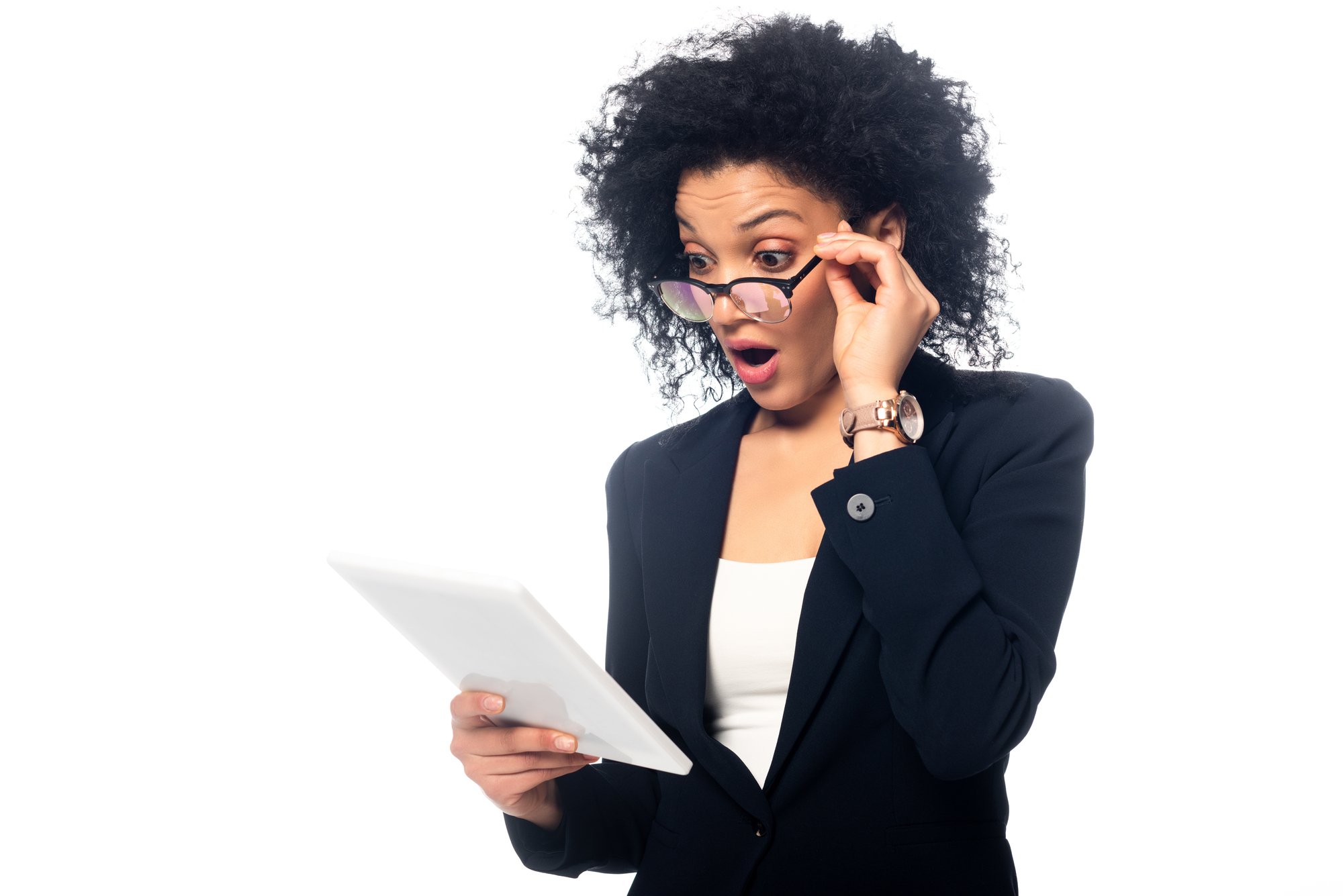 Shocked and surprised african american businesswoman looking at digital tablet isolated on white